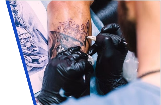 Tattoo artist applying ink